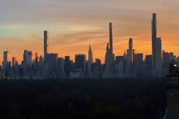 Central Park and supertall towers that line the park at sunset.